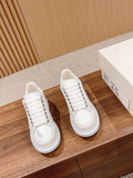 Pair of white Alexander McQueen sneakers, lace-up with chunky sole
