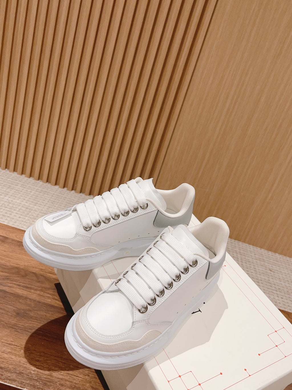 White Alexander McQueen sneakers, lace-up with studded detailing and thick sole