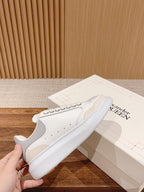 White Alexander McQueen leather sneaker with studded side and rounded toe