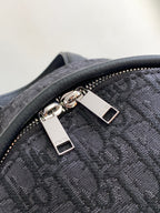Backpack zipper hardware with engraved pull and textured monogram fabric, dark