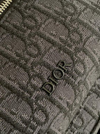 Dior men's monogram backpack close-up of fabric pattern and Dior logo emboss