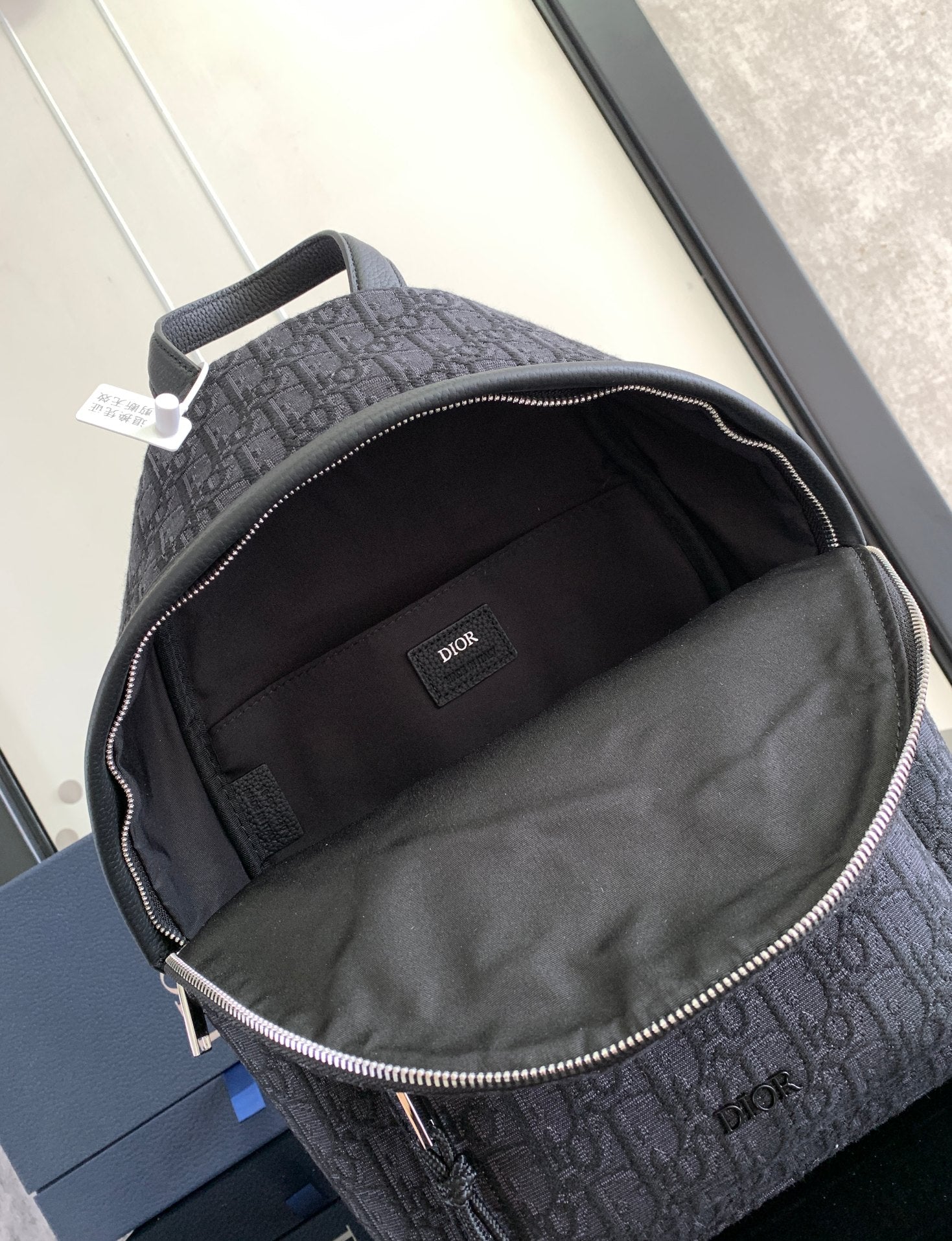 Dior monogram backpack open interior with black lining and small brand patch