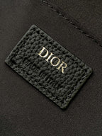 Dior logo on quilted lining patch inside the backpack, dark fabric