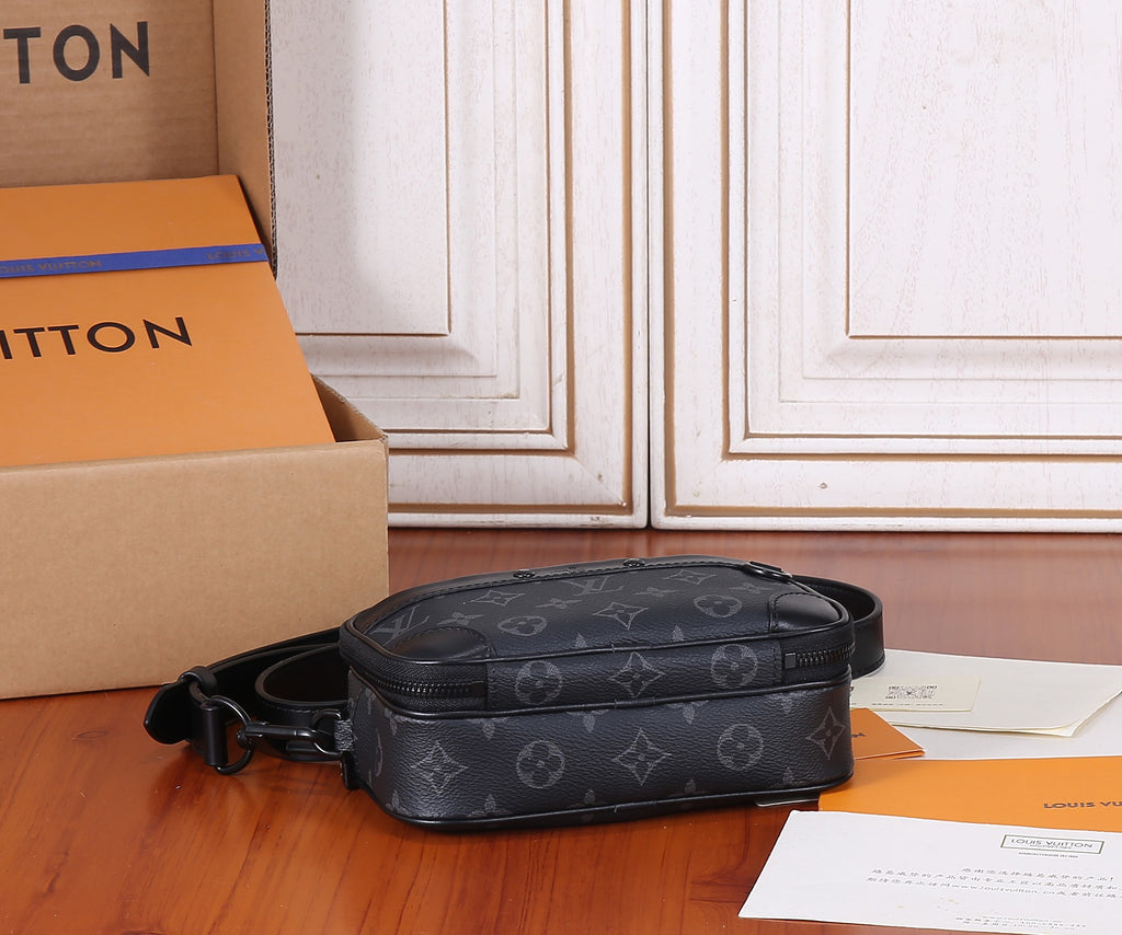 Louis Vuitton monogram crossbody bag shown from the side, with black strap and zip top