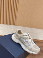 Dior unisex sneakers in light beige with gray emblem on side and white laces