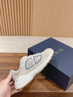 Dior unisex sneakers, light beige uppers with gray logo and white laces on blue box