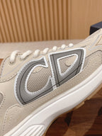 Dior unisex sneaker side detail with large gray “D” logo and beige trim