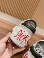 Dior unisex luxury shoes, white slide-in shoe with red Dior logo on strap panel