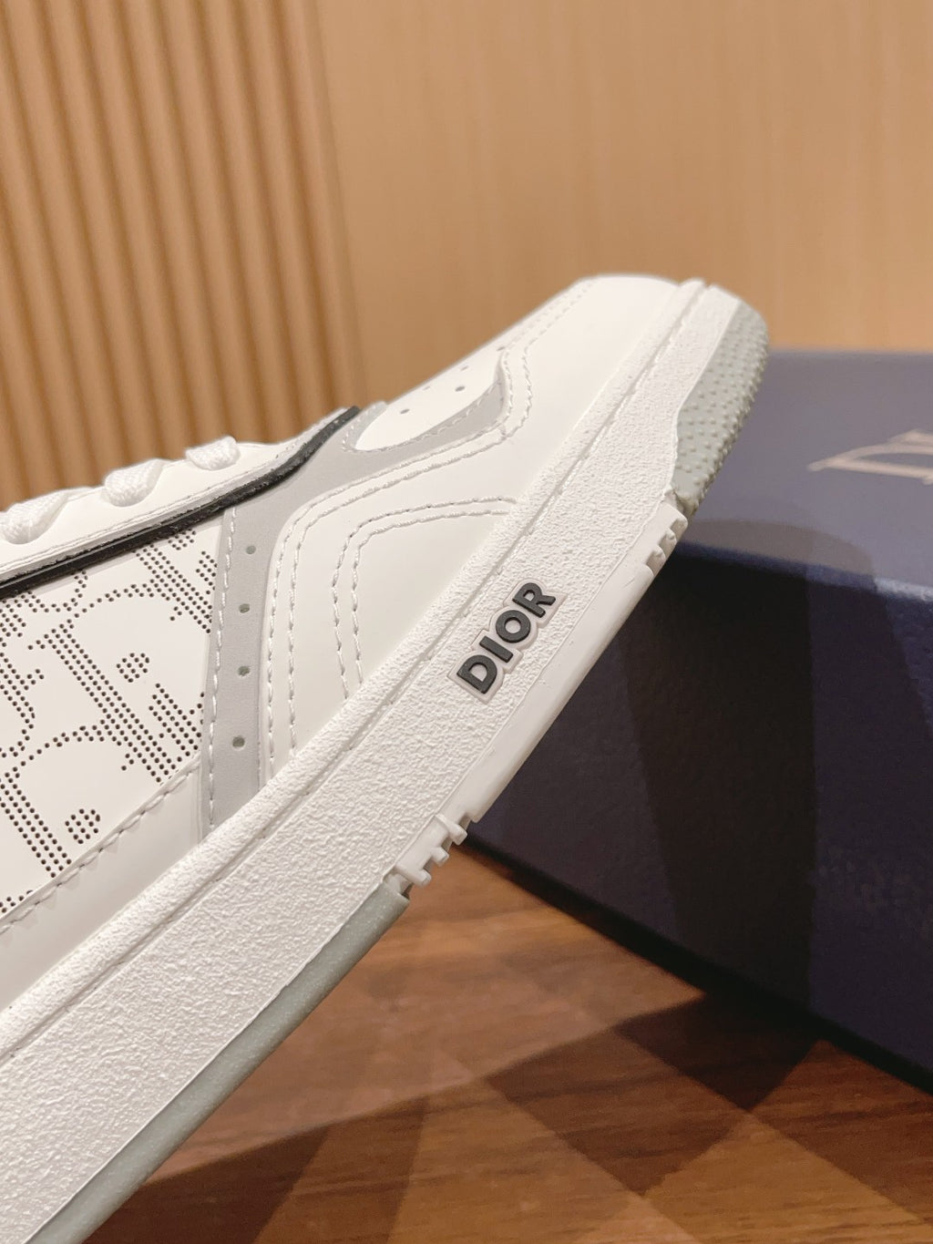 Dior unisex luxury shoes, side view close-up of white sole with Dior logo detail