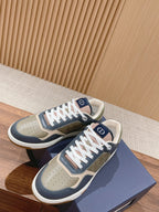 Dior low-top sneakers pair in navy and cream with monogram inserts and white laces