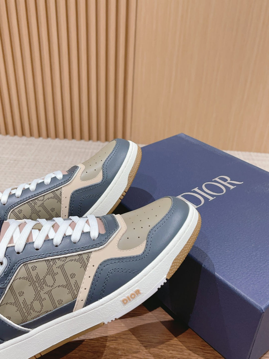 Dior low-top sneakers with navy and cream uppers, monogram toe panel and white laces