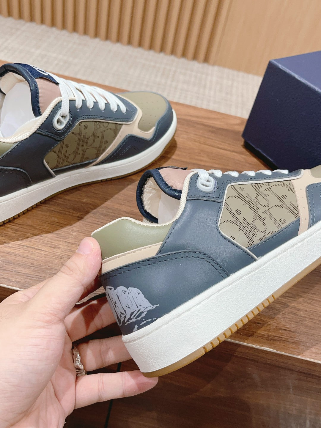 Dior low-top sneakers in navy and cream with monogram side panel and white laces
