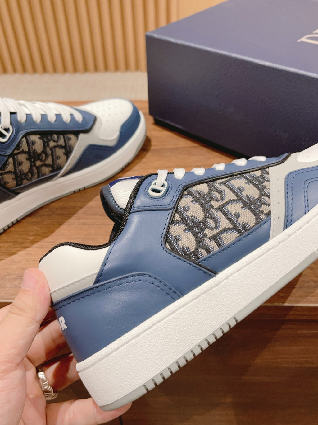 Unisex sneakers with blue strap detail, patterned side insert, and white sidewall