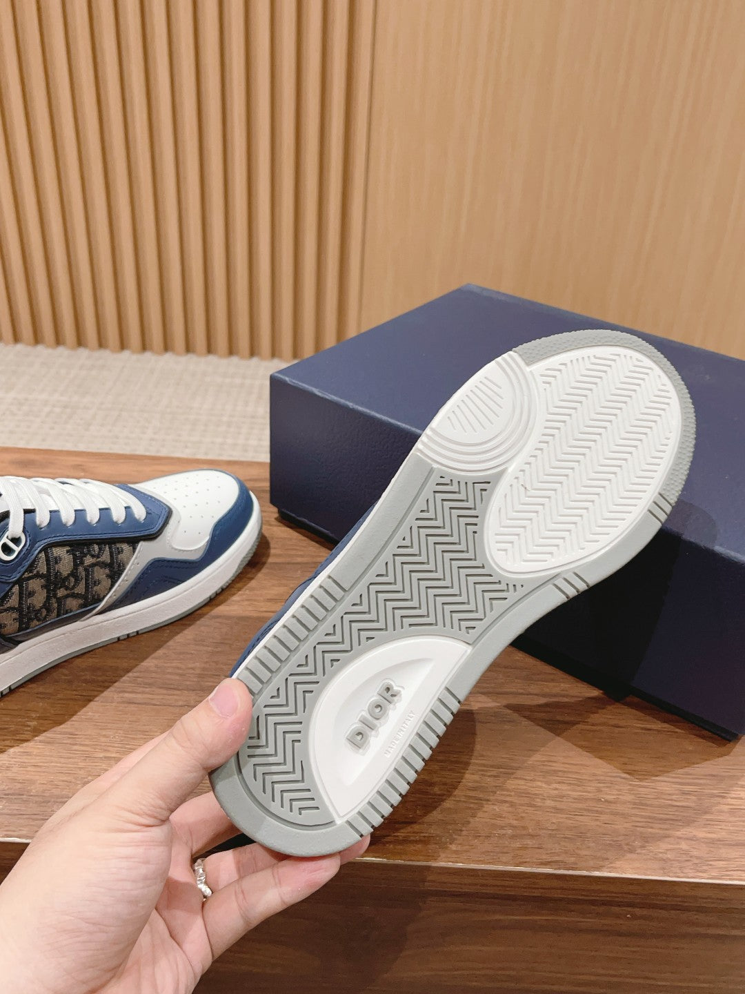 Unisex sneaker outsole view with textured tread and white midsole edge
