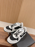 Unisex low-top sneaker pair, black and white, lace-up and side emblem