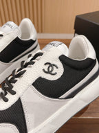 Unisex sneaker close-up, black and white leather with side emblem and laces