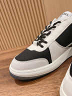 Unisex sneakers side view, black and white leather, lace-up, side emblem
