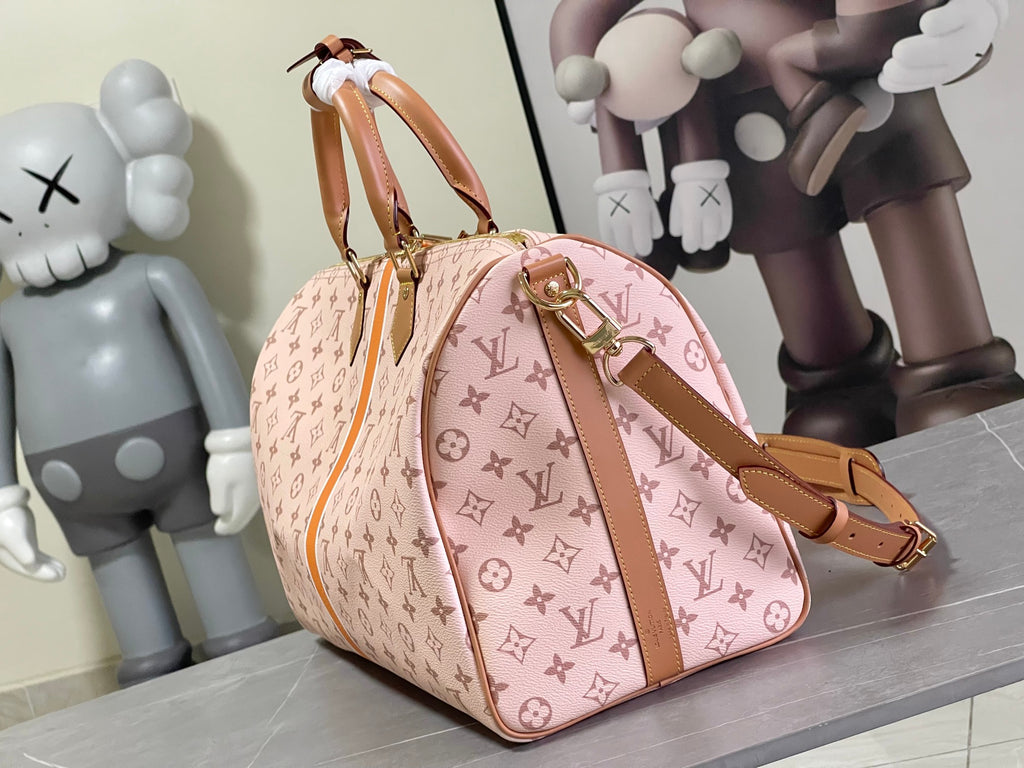 Pink monogram duffel bag with tan trim and top handle strap