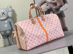 Pink monogram duffel bag with tan crossbody strap and rolled handles