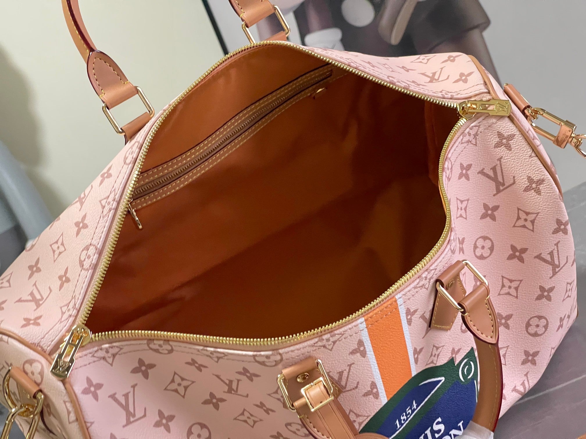 Pink monogram duffel bag open interior with tan lining and zipper pull