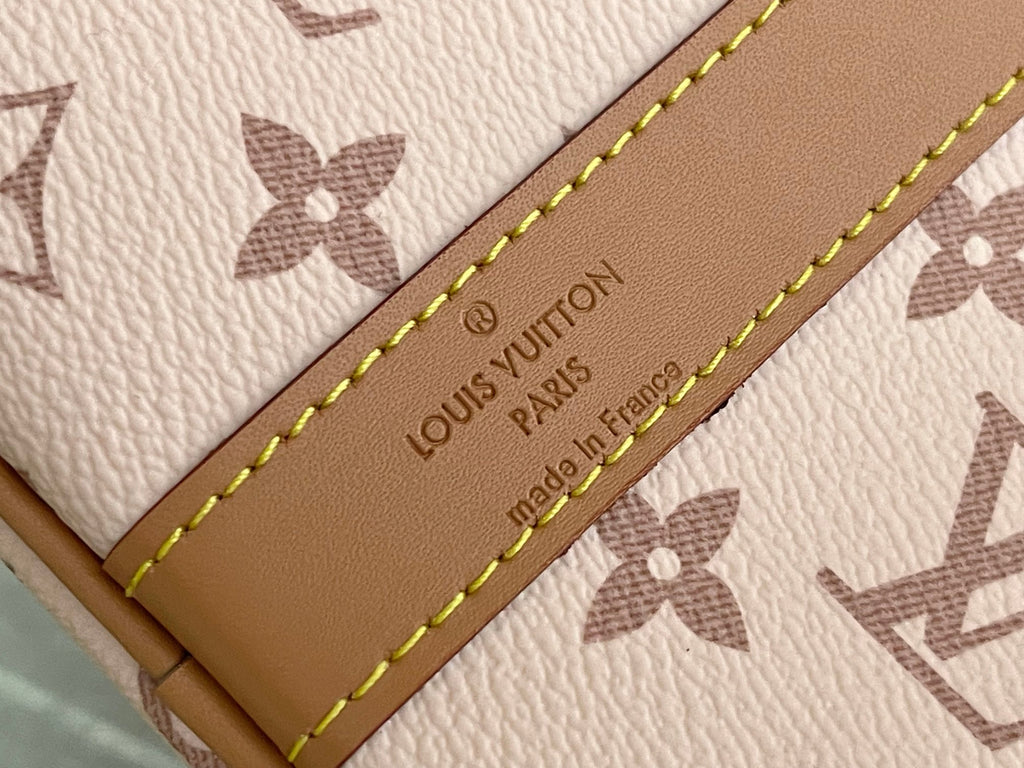 Beige leather tag on Louis Vuitton bag with embossed 'Louis Vuitton Paris' text