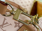 Gold-tone key ring clasp on tan-and-pink monogram bag strap
