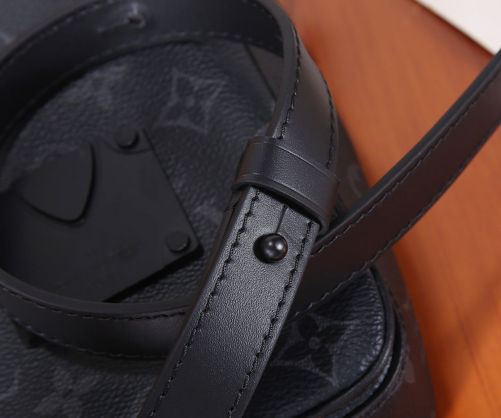Louis Vuitton monogram bag corner detail with leather strap and button snap.