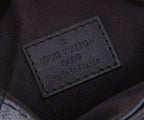 Louis Vuitton brand label patch on the interior of a dark monogram bag.