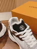 Louis Vuitton unisex sneaker close-up, black heel with LV-style emblem, white laces