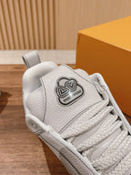 White leather sneaker with Louis Vuitton logo patch on tongue, lace-up close-up