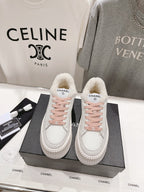 Chanel white low-top sneakers with pink lace-up detailing and plush sherpa lining