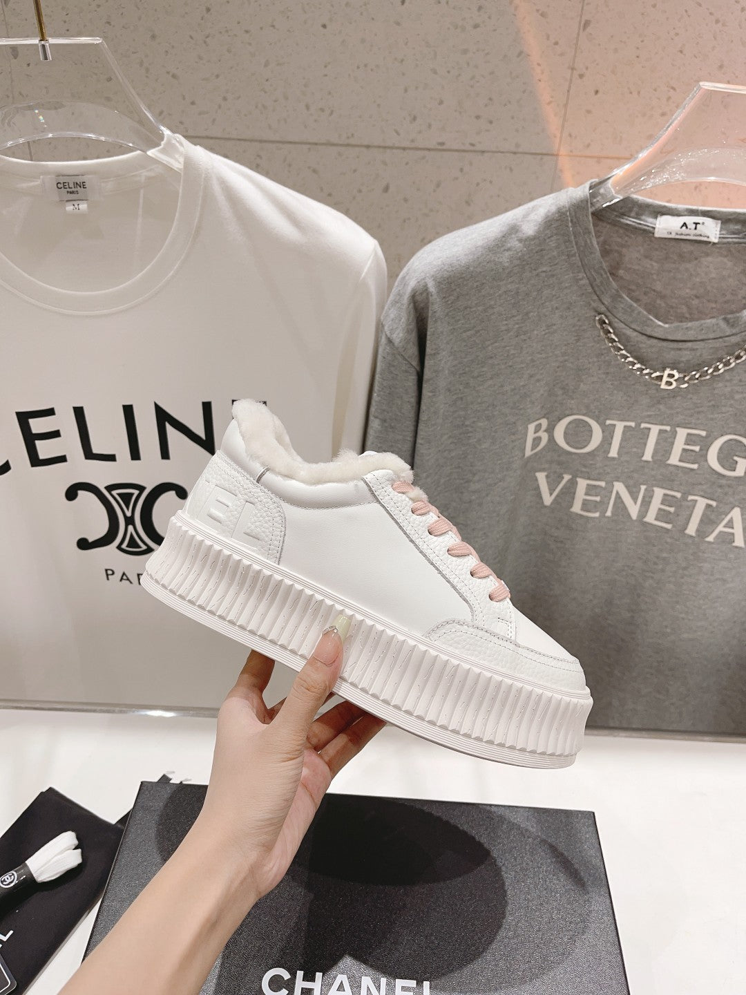 Chanel white sneaker with pink lace trim and textured platform sole