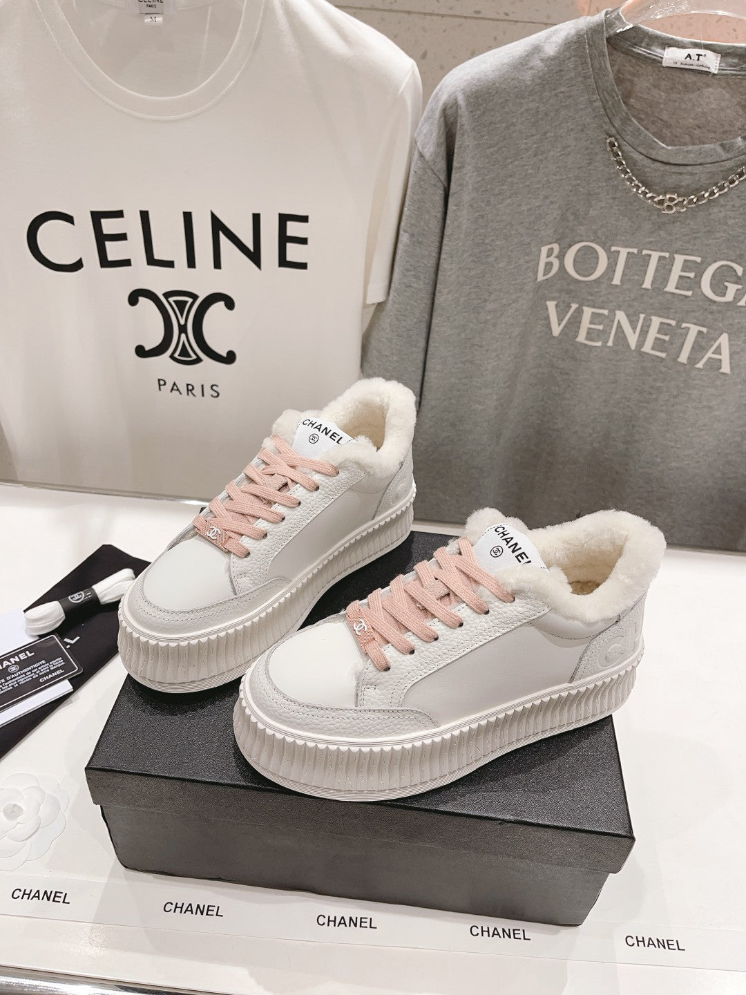 Chanel white sneakers with pink laces and fluffy sherpa lining around the collar