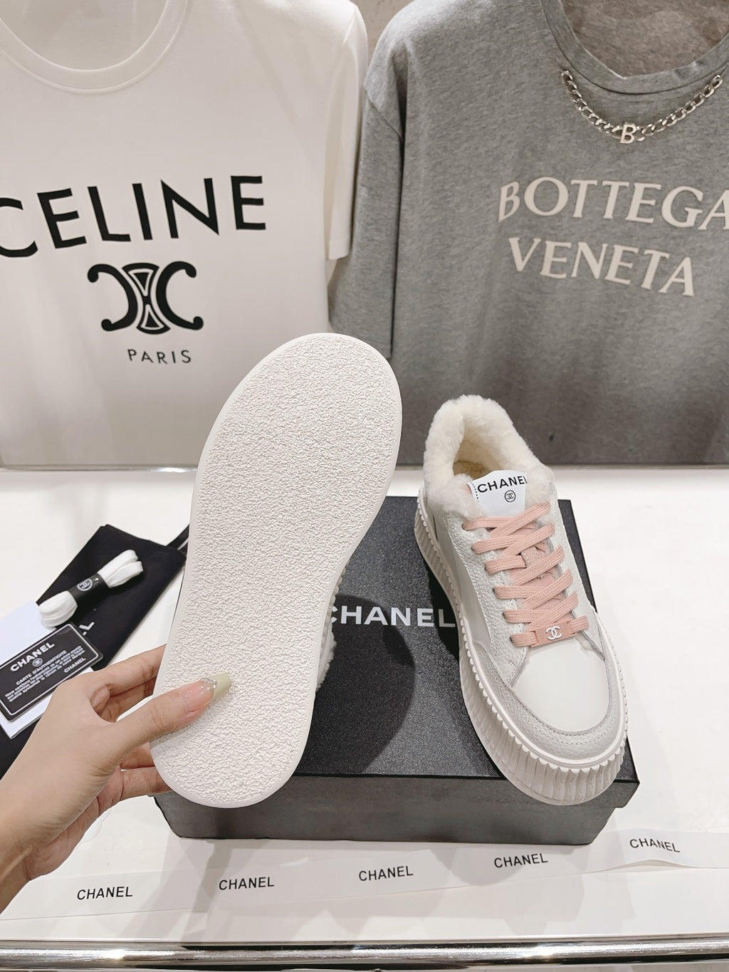 Chanel white sneaker outsole and side view with pink laces and sherpa lining