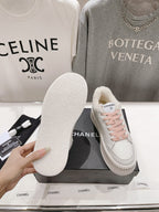Chanel white sneaker outsole and side view with pink laces and sherpa lining