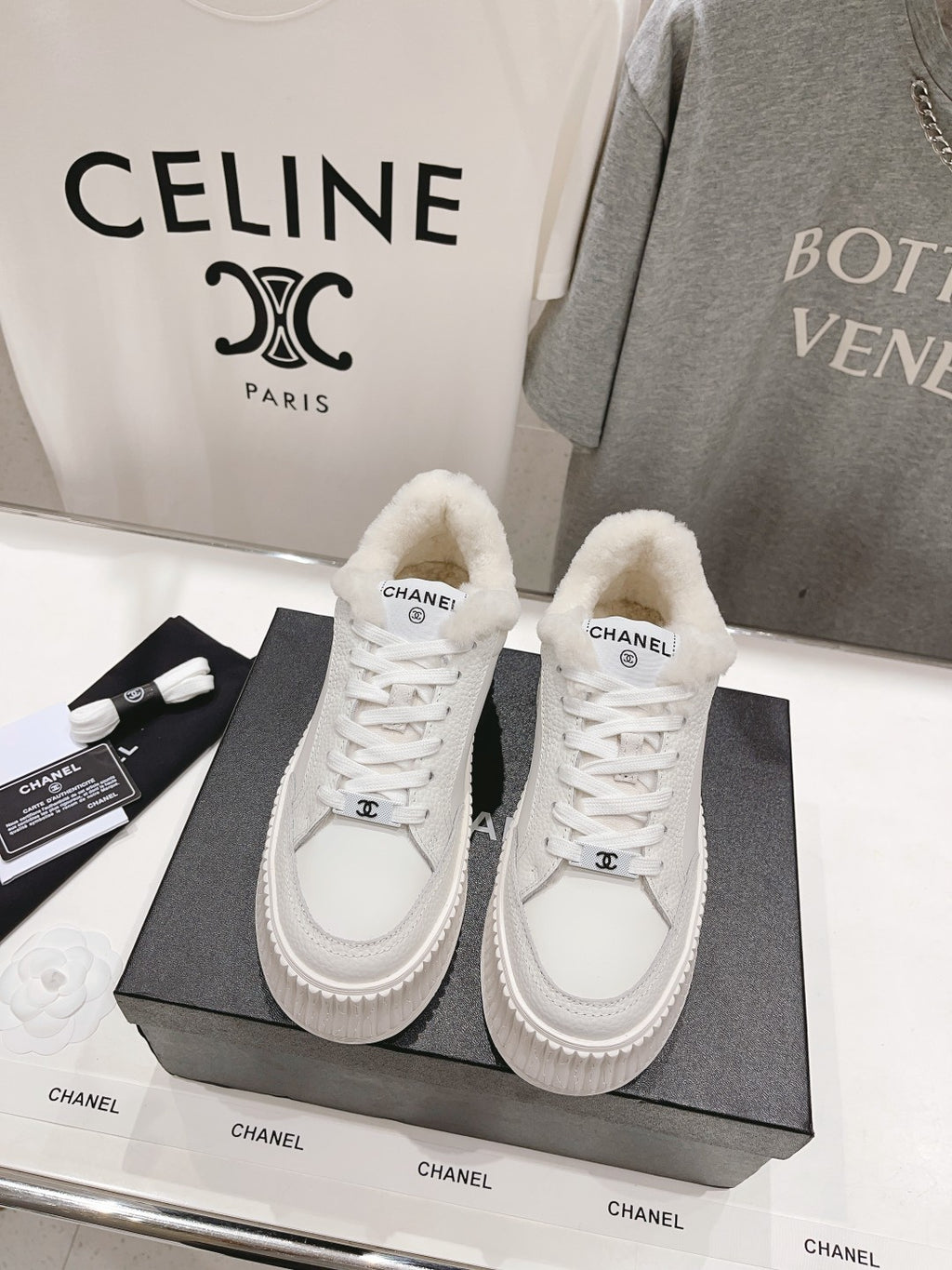 White lace-up sneakers with fuzzy shearling lining and chunky platform sole