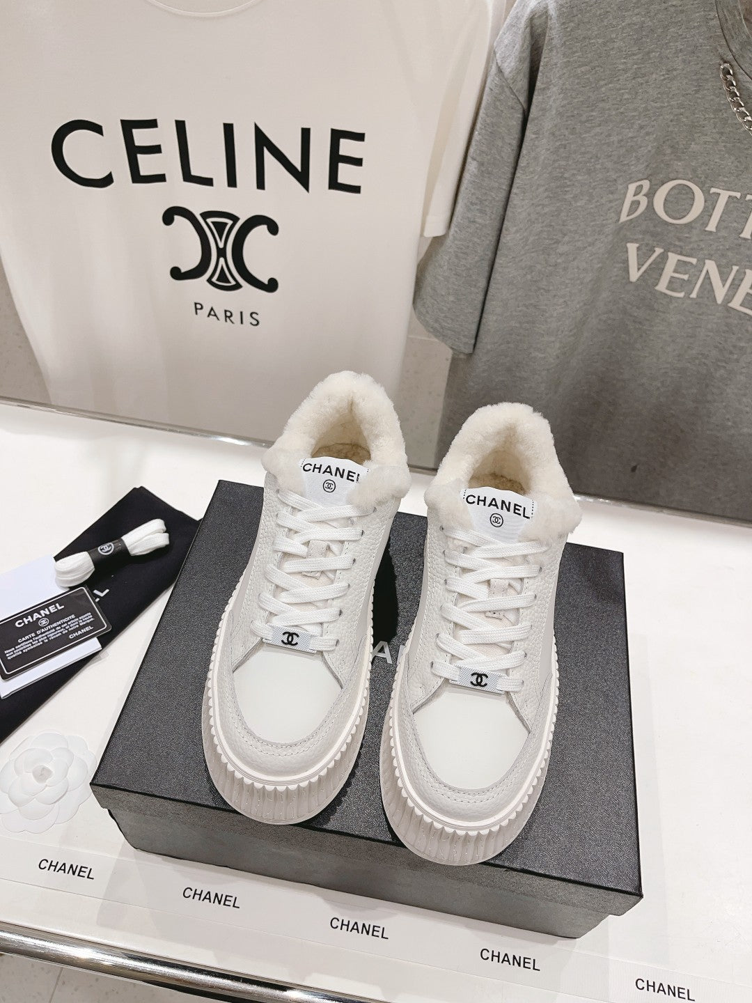 White lace-up sneakers with fuzzy shearling lining and chunky platform sole