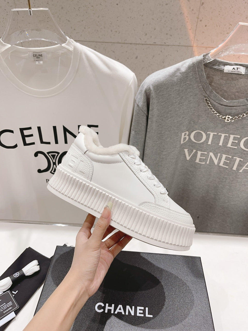 White lace-up sneaker with plush collar and ribbed platform sole, side view