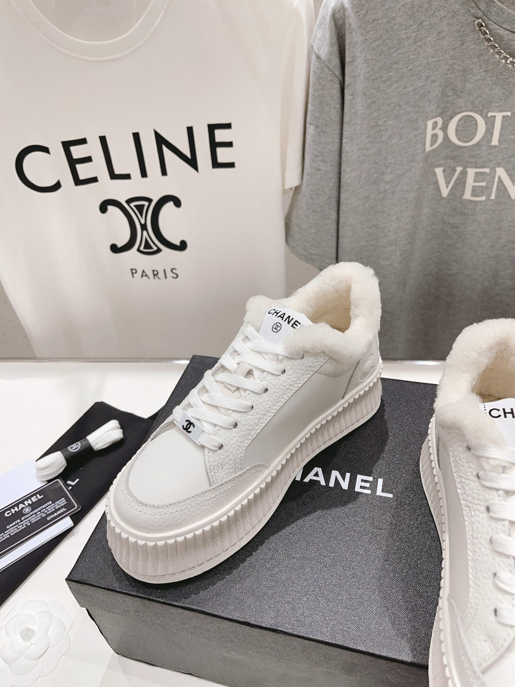 White lace-up sneakers with plush lining and chunky ribbed sole, side view