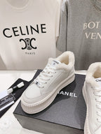 White lace-up sneakers with plush lining and chunky ribbed sole, side view