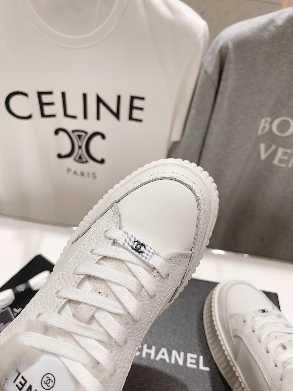 White lace-up sneaker with plush collar and ribbed platform sole, toe close-up
