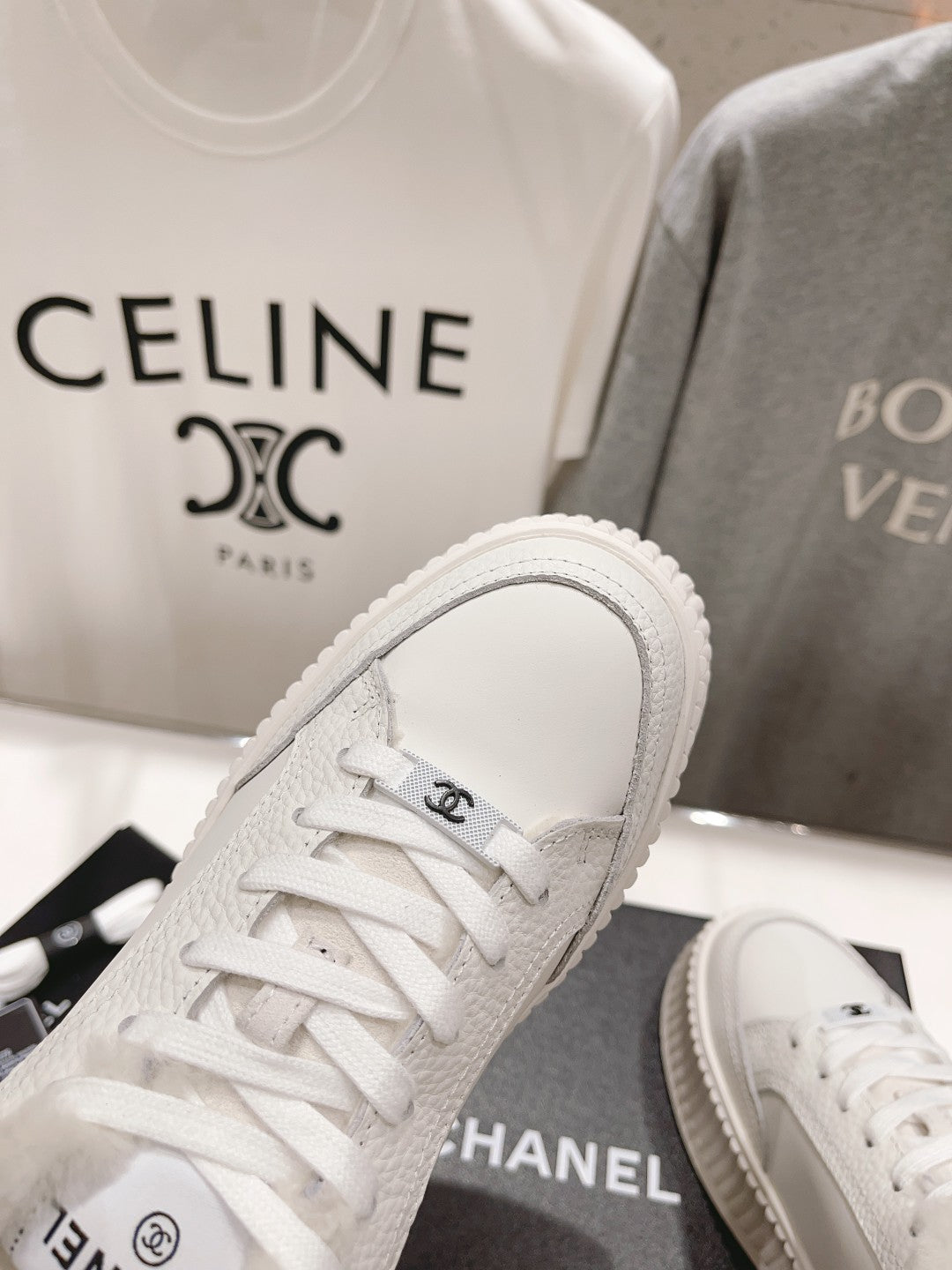 White lace-up sneaker with plush collar and ribbed platform sole, toe close-up