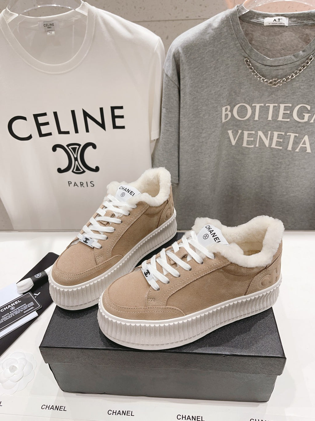 Pair of women’s beige Chanel sneakers with shearling lining and white platform sole