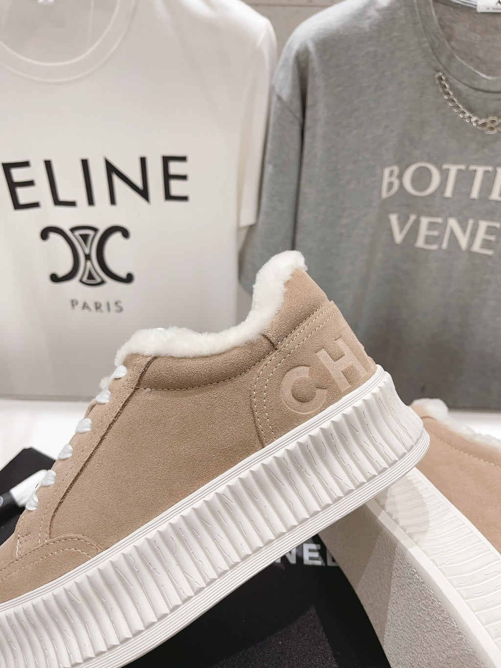 Women’s beige Chanel suede sneakers with white ribbed sole and plush fur collar