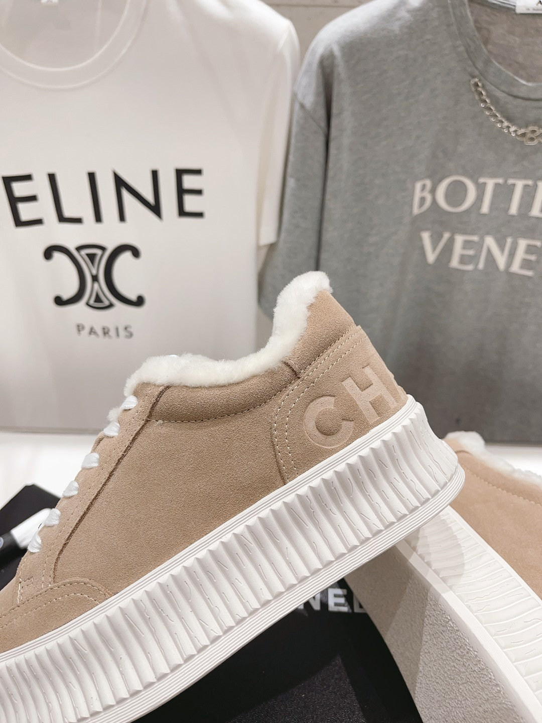 Women’s beige Chanel suede sneakers with white ribbed sole and plush fur collar