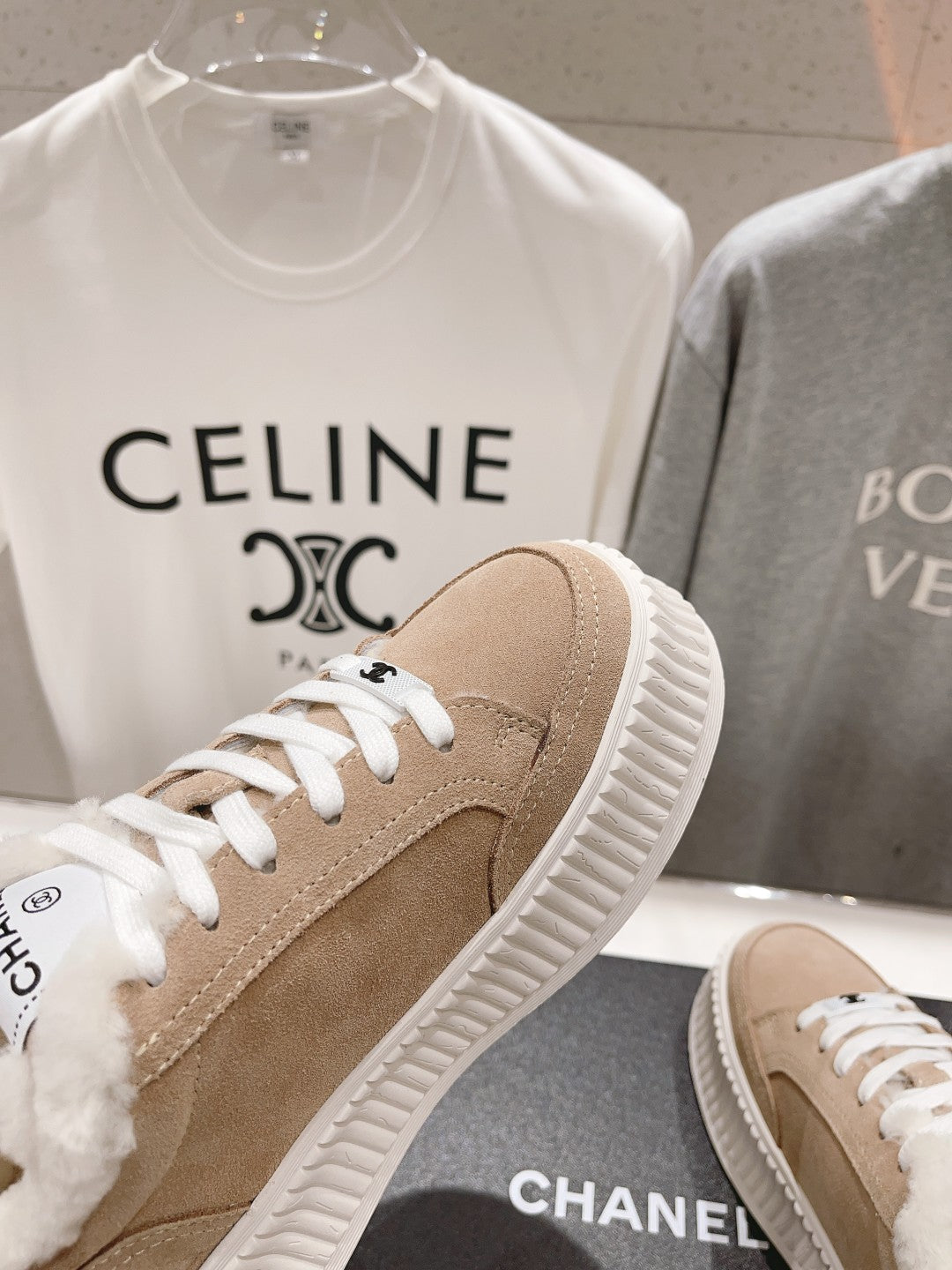 Women’s beige Chanel sneaker, white laces, ribbed sole, plush shearling trim