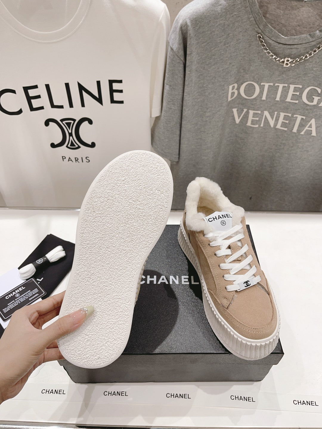 Women’s Chanel sneaker with outsole shown; beige suede upper, white lace-up top