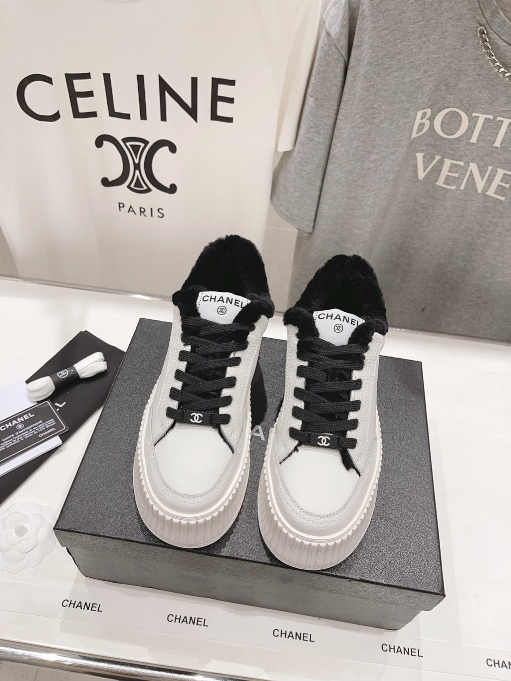 Women’s Chanel luxury sneakers, white leather with black faux-fur trim and platform soles