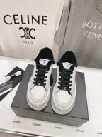 Women’s Chanel luxury sneakers, white leather with black faux-fur trim and platform soles