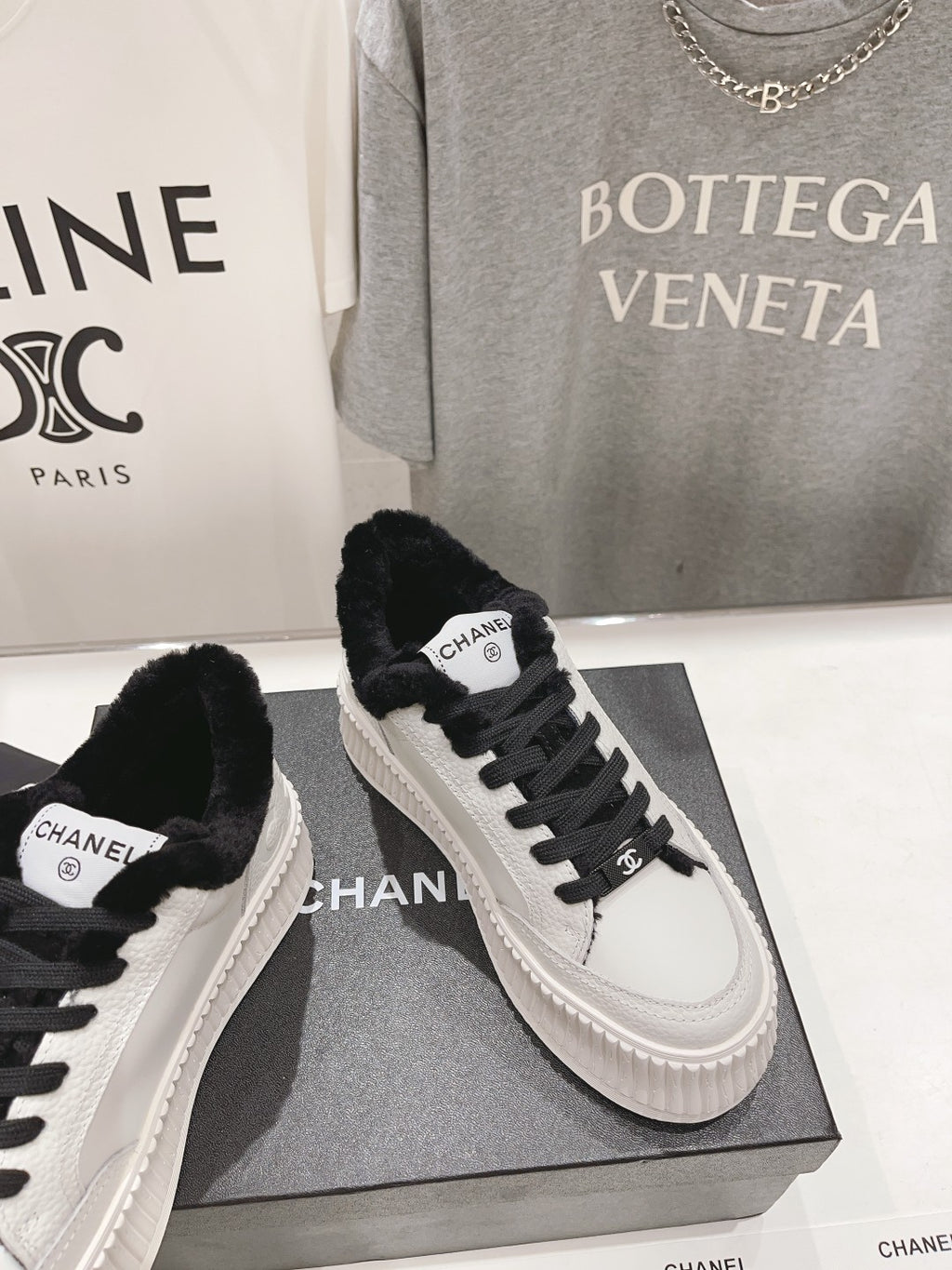 Women’s Chanel sneakers, white leather uppers with black laces and faux-fur collar